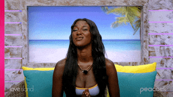 Reality TV gif. Zeta on Love Island USA squints one eye and pretends to be sneaking a peek at something.