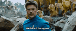 Movie gif. Scuffed and bloody, Chris Pine as Captain Kirk in Star Trek Beyond says through gritted teeth, "Well that's just typical," which appears as text.