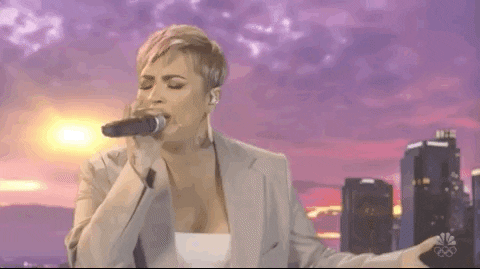 Demi singing in front of city