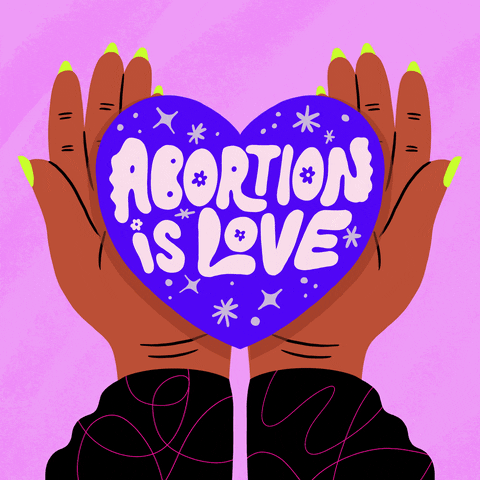 Text gif. Hands with green nail polish on a pink background hold a purple heart that reads "abortion is love."