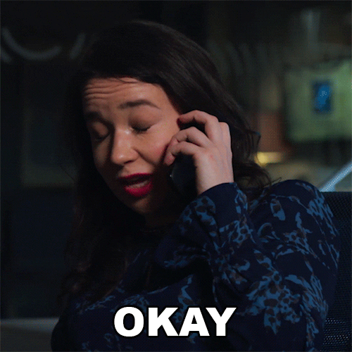 TV gif. Sarah Steele as Marissa Gold in The Good Fight, cell phone to her ear, eyes closed as if pain, shakes her head apprehensively, but willingly says, "Okay."