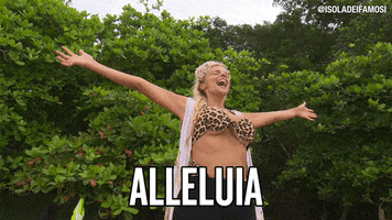 Reality TV gif. Francesca from Isola dei Famosi spreads her arms wide open and shouts for joy. Text, "alleluia."