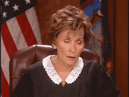 Reality TV gif. Judge Judy emphatically rolls her eyes behind the bench.