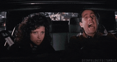 Seinfeld gif. Julia Louis-Dreyfus as Elaine with Jerry while he's driving, both of them laughing.