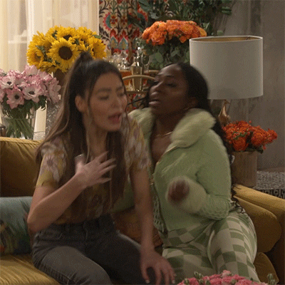 TV gif. Miranda Cosgrove as Carly Shay from iCarly is reeling from some serious drama, and fans herself as she takes a seat on a couch. A supportive friend sitting next to her fans her as well. Text, "Oh my god!"