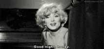 Movie gif. Marilyn Monroe as Sugar Kane in Some Like it Hot smiles and says "good night, honey," before dipping back behind a curtain.