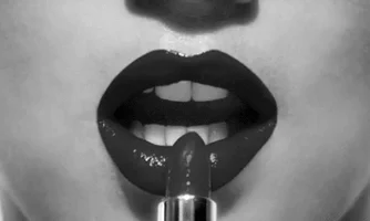 close up of black lipstick being applied to lips