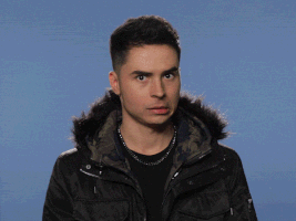 Celebrity gif. Musician Reykon gives us a worried look before breaking into a smile and nodding, clapping, and giving us a thumbs up.