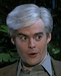 SNL gif. Gray-haired Bill Hader appears pleasantly surprised as a mischievous grin spreads across his face.