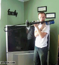 Gif of a man playing a trombone with flames coming out of it