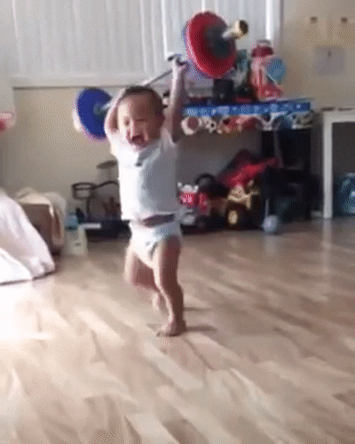 Toddler throwing a barbell