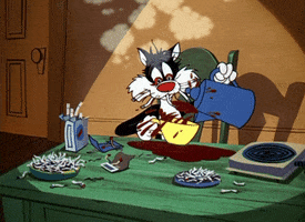 Cartoon gif. Sylvester the Cat on Looney Tunes. He's trying to pour a cup of coffee but is so shaky that it splashes out of the cup. The table is littered with used cigarettes and he's totally cracked out.