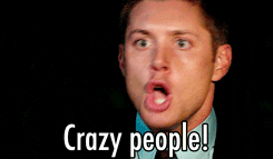 TV gif. Jensen Ackles as Dean Winchester in Supernatural shakes his head and stares at someone with wide, angry eyes as he yells, “Crazy people!”