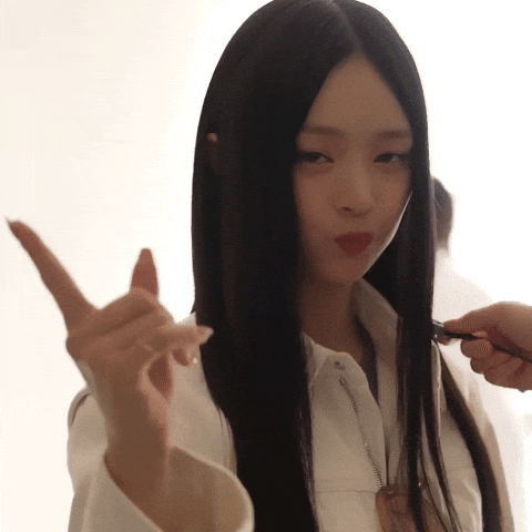 Celebrity gif. NewJeans member Hanni Pham wags her finger at us while she cutely shakes her head and frowns with her lips puckered and cheeks puffed. 