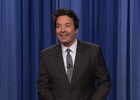 TV gif. Jimmy Fallon on The Tonight Show does a little running man dance and then erupts into complete excitement. Bouncing around with his hands waving frantically, and his mouth open wide like he’s screaming. He can't control how excited he is and looks around to see if anyone else feels the same. 