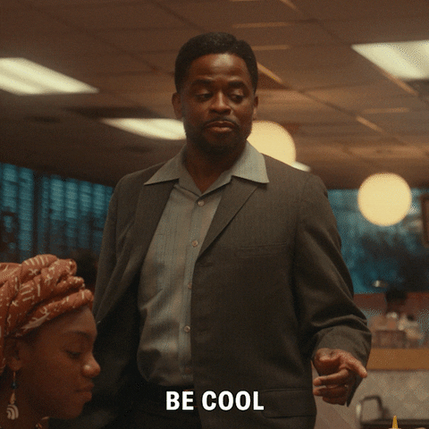 TV gif. Dule Hill as Bill Williams on The Wonder Years walks up to a table at a restaurant and winks as he says, “Be cool.”