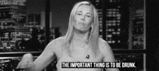 Celebrity gif. Chelsea Handler looks directly at us, places her hand on a desk in emphasis, and tilts her head forward. Text, "The important thing is to be drunk."