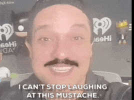 PopCultureWeekly pop culture weekly laughing at mustache laughing at his mustache funny mastache GIF