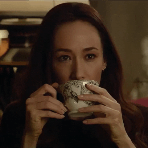 Celebrity gif. Sipping her tea, a bothered Maggie Q rolls her eyes, then puts down her cup in annoyance.