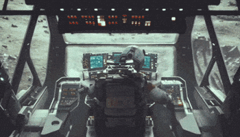 Video gif. View of the back of a pilot in a spaceship cockpit operating the controls to land on a moon-like surface where we can see a rover walking across. 