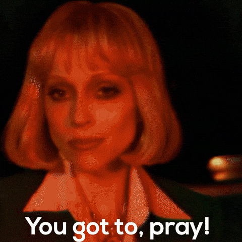 Music video gif. St. Vincent in Pay Your Way In Pain sings and looks at us as the image blurs and fades to her raising her hands in prayer. Text, "You got to, pray!"