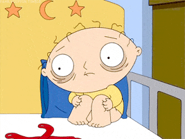 Family Guy gif. Stewie sits in the corner of his crib rocking back and forth. His hair is all frazzled, huge bags under his eyes and a far away stare that is full of fear.