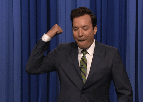 The Tonight Show gif. Jimmy Fallon is fist pumping and he starts bouncing and pursing his lips as he pumps.