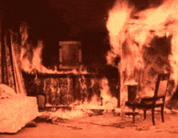 Video gif. Room inside a house is engulfed in flames.