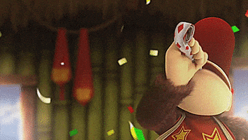 Video game gif. Diddy Kong blows a red and white party horn ribbon at us while confetti slowly falls.