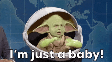 SNL gif. During a "Weekend Update" segment, Kyle Mooney as Baby Yoda mugs to the audience from inside an oversized helmet. Text, "I'm just a baby!"