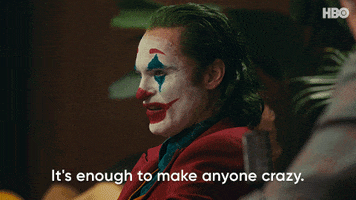 Movie gif. Joaquin Phoenix as the Joker in Joker turns toward us with disdain and says, "It's enough to make anyone crazy."