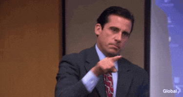 The Office gif. Standing in the conference room, Steve Carell as Michael points a finger at two different people and says, “Boom, boom!”