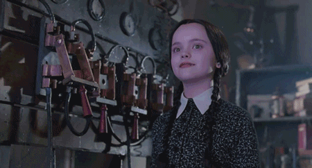 Gif of Wednesday Addams smiling in a gloriously terrifying way.