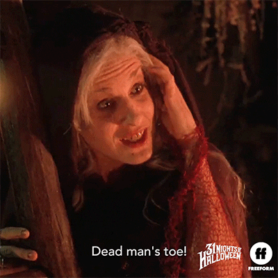 Movie gif. Sarah Jessica Parker as Sarah in Hocus Pocus. She's hugging a ladder and she grins and points her hand while saying, "Dead man's toe!"