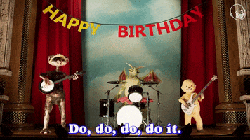 Video gif. The Eternal Family Animatronic Band sway as they play on a stage beneath a happy birthday banner. Text, "Do, do, do, do it. You go it."
