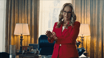 Movie gif. Meryl Strep as President Orlean in Don't Look Up. She has her arms crossed and she puts a hand up to stop someone before smiling and pointing at them.