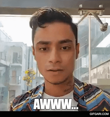 Video gif. Rakin Absar, a Youtuber, leans into the camera and scrunches his face, cooing at us and saying, "Aww."