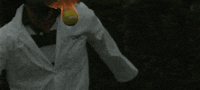 Sport gif. Player starts their swing as a flaming tennis ball comes down in slow motion, and we anticipate the racket making direct contact with the fireball.