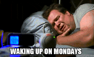 TV gif. Eric Stonestreet as Cameron from Modern Family lies in bed crying, while devices glow at him from a bedside table in the foreground. Text, "Waking up on Mondays."