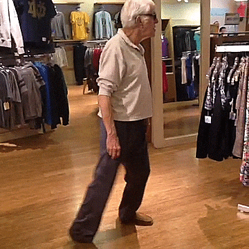 Celebrity gif. In a clothing store, Dick Van Dyke wearing sunglasses dances groovily. He doesn't care who's watching, he needs to groove!
