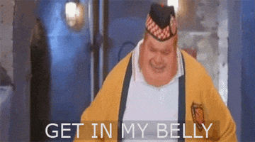 Movie gif. Mike Myers as Fat Bastard in Austin Powers: The Spy Who Shagged Me, points at his stomach and screams angrily, "Get in my Belly."