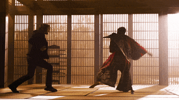 Movie gif.  Keanu Reeves as Neo and Yahya Abdul Mateen II as Morpheus in Matrix: Resurrections. Both of them are fighting in a dojo and Morpheus gets hit heavily by Neo, flying into the air at the force of Neo's attack.