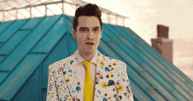 Music video gif. From the video for Taylor Swift's "Me," Brendon Urie opens his floral-print suit jacket, revealing a heart-shaped tunnel.