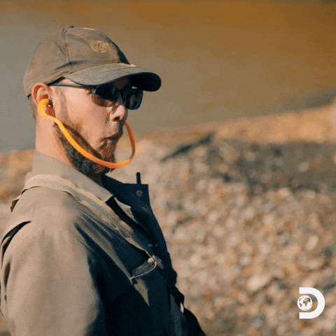 TV gif. Kevin Beets from Gold Rush with a surprised but excited expression high fives another person.
