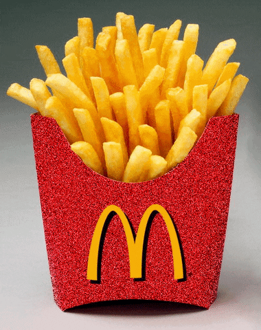 A Mcdonalds fry holder with fries inside. The holder is red and glittery