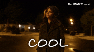 TV gif. Sophie Thatcher as Becky in When the Streetlights Go On shrugs with her hands in her pockets as she stands in the middle of a street at night and casually says, "Cool."