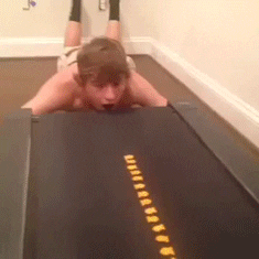 Video gif. Cheez-Its arranged on a treadmill roll directly into a boy's mouth, first as a straight line and then as a curved line.