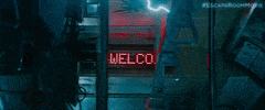 Movie gif. From Escape Room, lightning strikes chaotically around the inside of a jolting subway car, which appears to be breaking down. Text on the digital sign on the ceiling reads "welcome back."