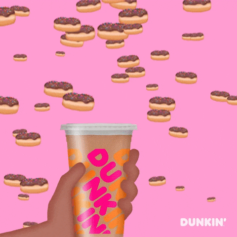 Ad gif. A cartoon hand holds a Dunkin' Donuts cup as chocolate donuts with sprinkles fall from the sky. The hand catches three donuts on top of the cup. Text, "National Donut Day."