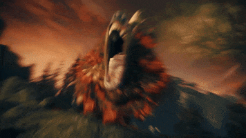 Video game gif. From Software's Shadow of the Erdtree DLC for Elden Ring. A ferocious beast roars as flames erupt around it and its roar creates a sonic blast that reverberates. 